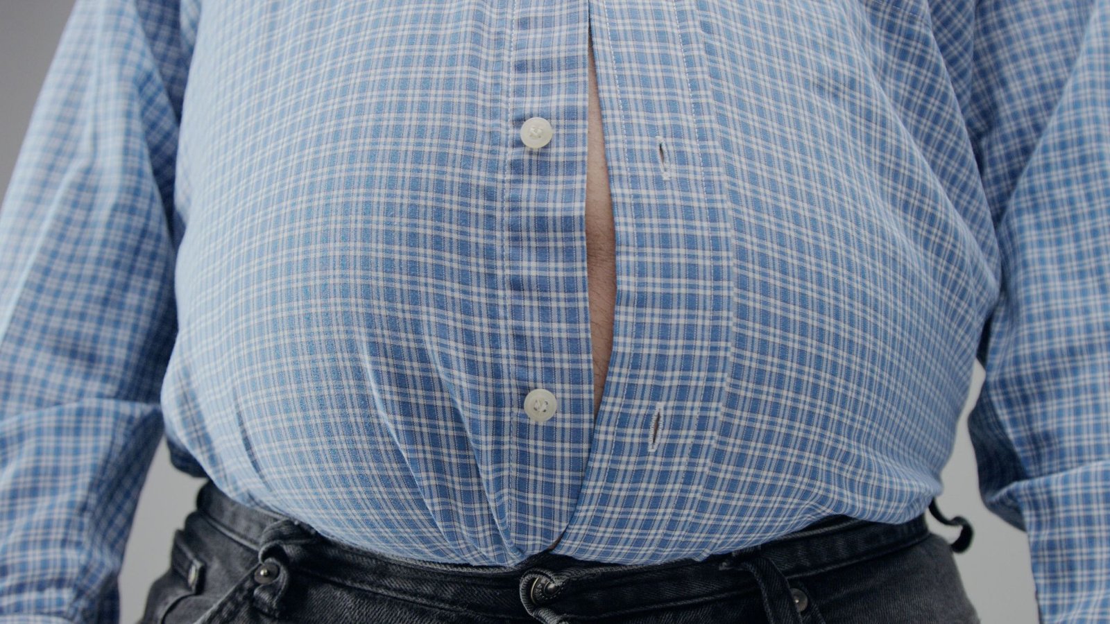 overweight man shrt is small him with huge belly open buttons