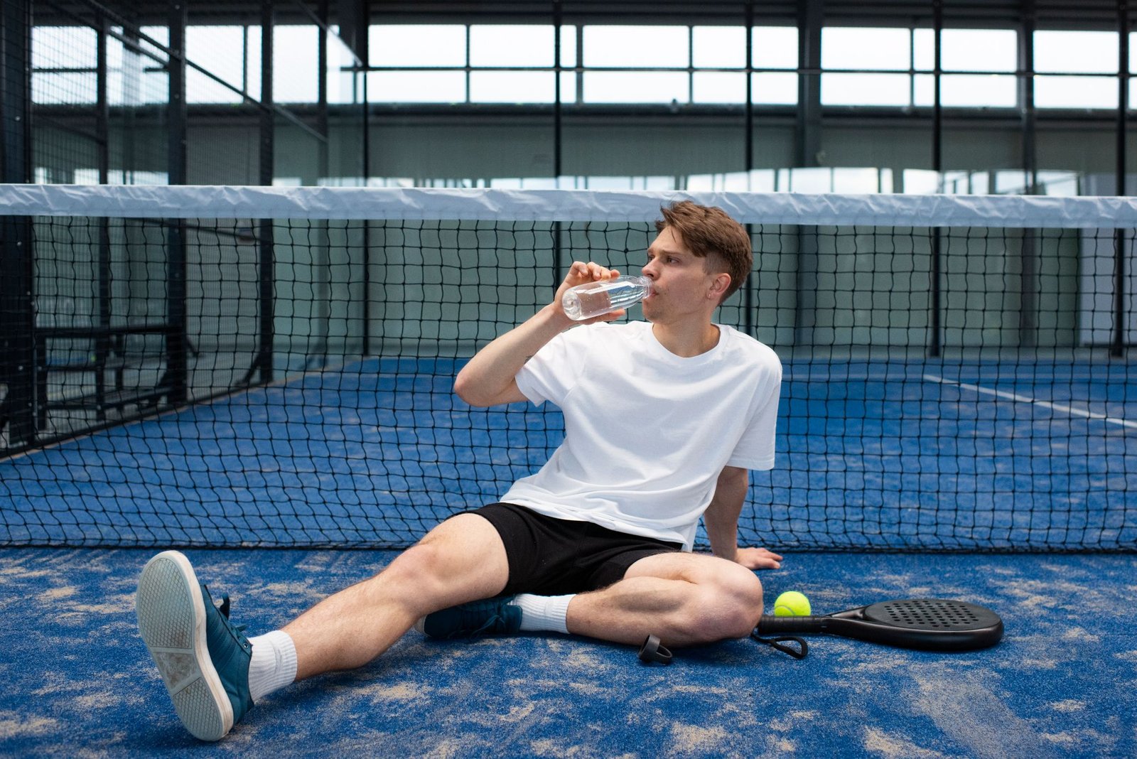 person getting ready play paddle tennis inside