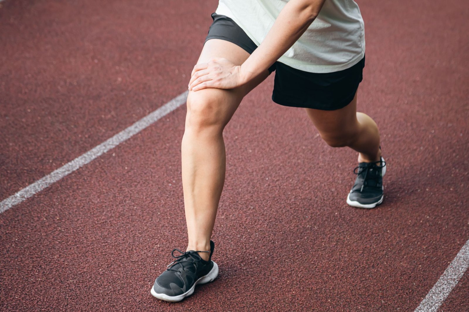 sports stretching exercise with woman outdoor track athlete woman stadium legs stretch fitness muscle warm up body wellness